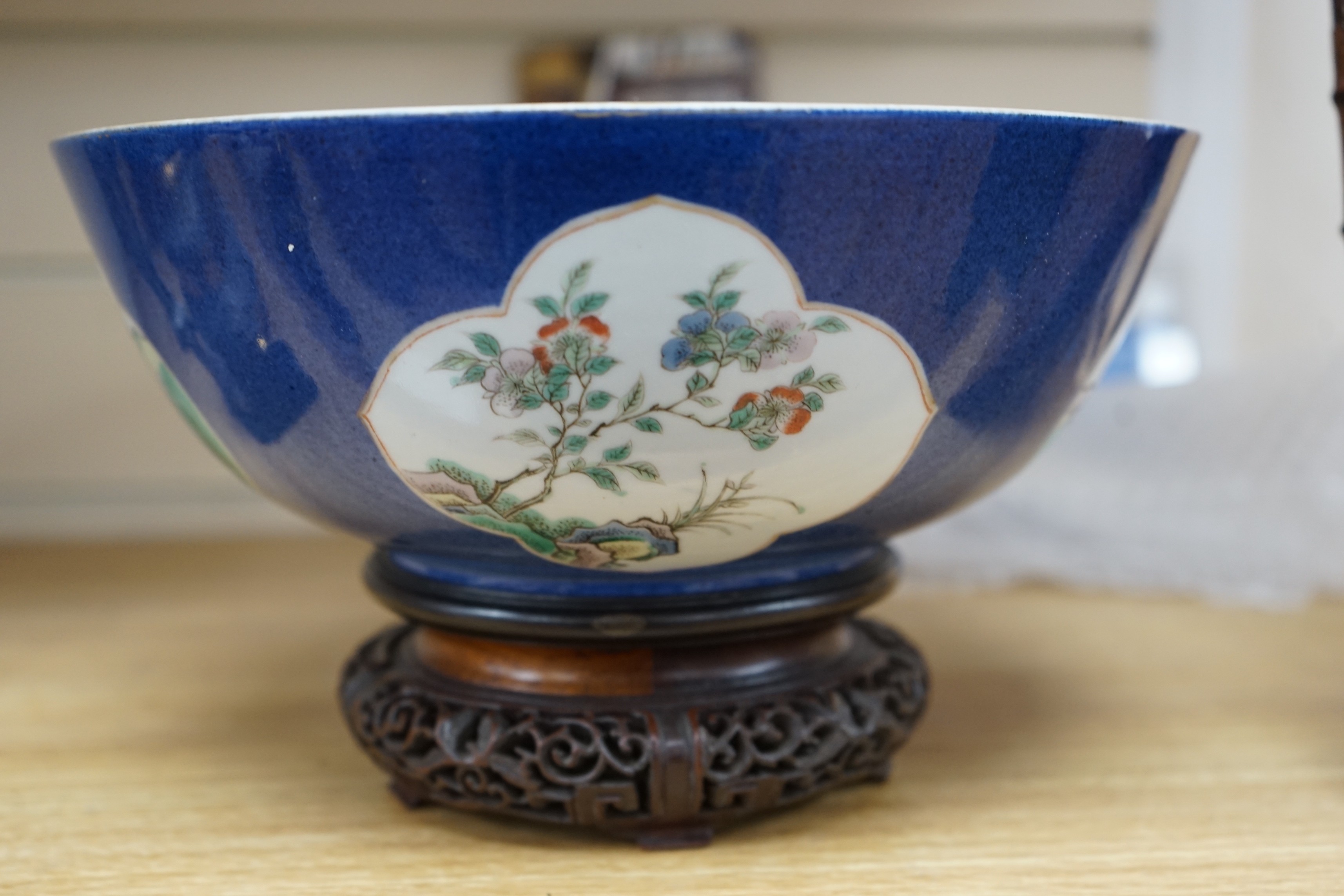 A 19th century Chinese famille verte powder blue bowl, 26cm diameter, wood stand